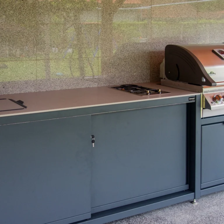 Outdoor kitchen with Napoleon grill, gas hob, and sink cover