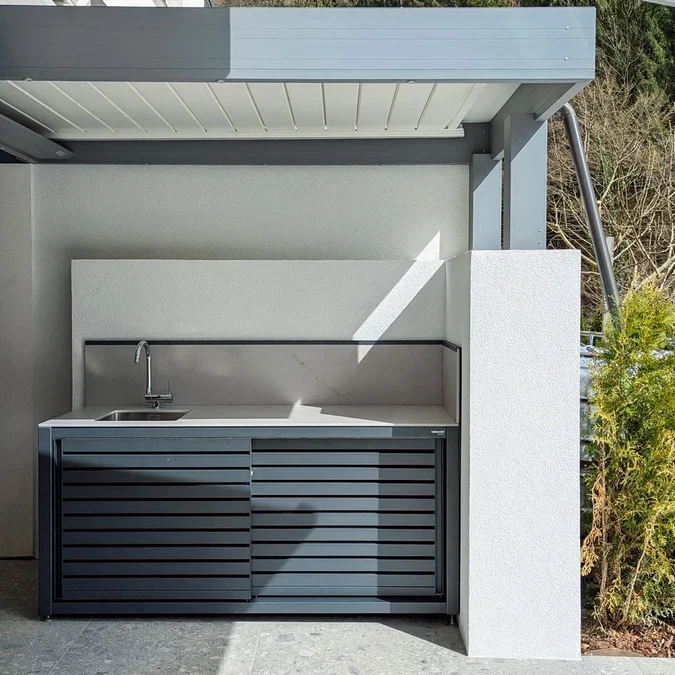 Dukin outdoor kitchen with raised back panel to protect wall from dirt